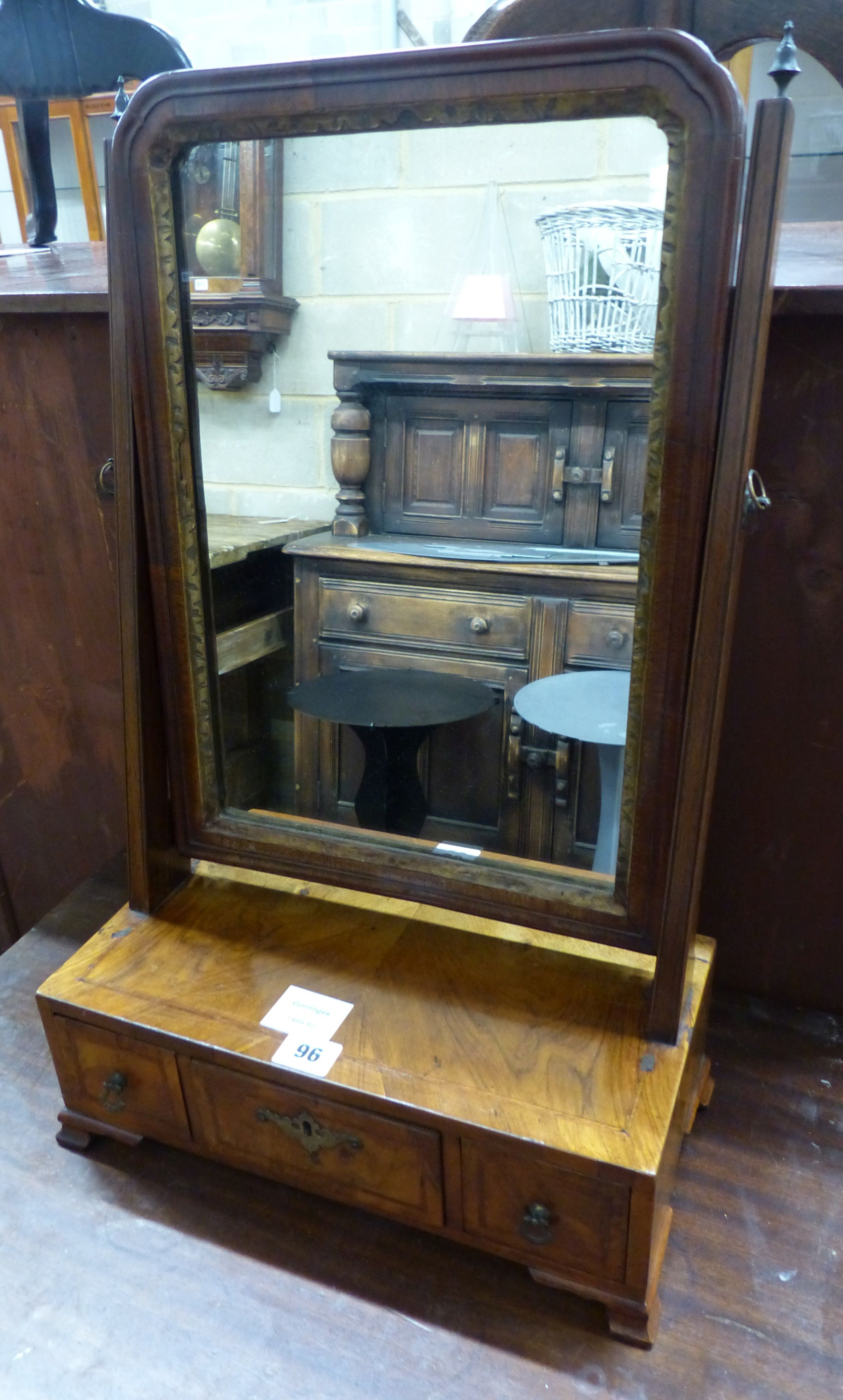 An 18th century and later figured walnut toilet mirror, the box base fitted with three drawers, W.36cm D.18cm H.58cm